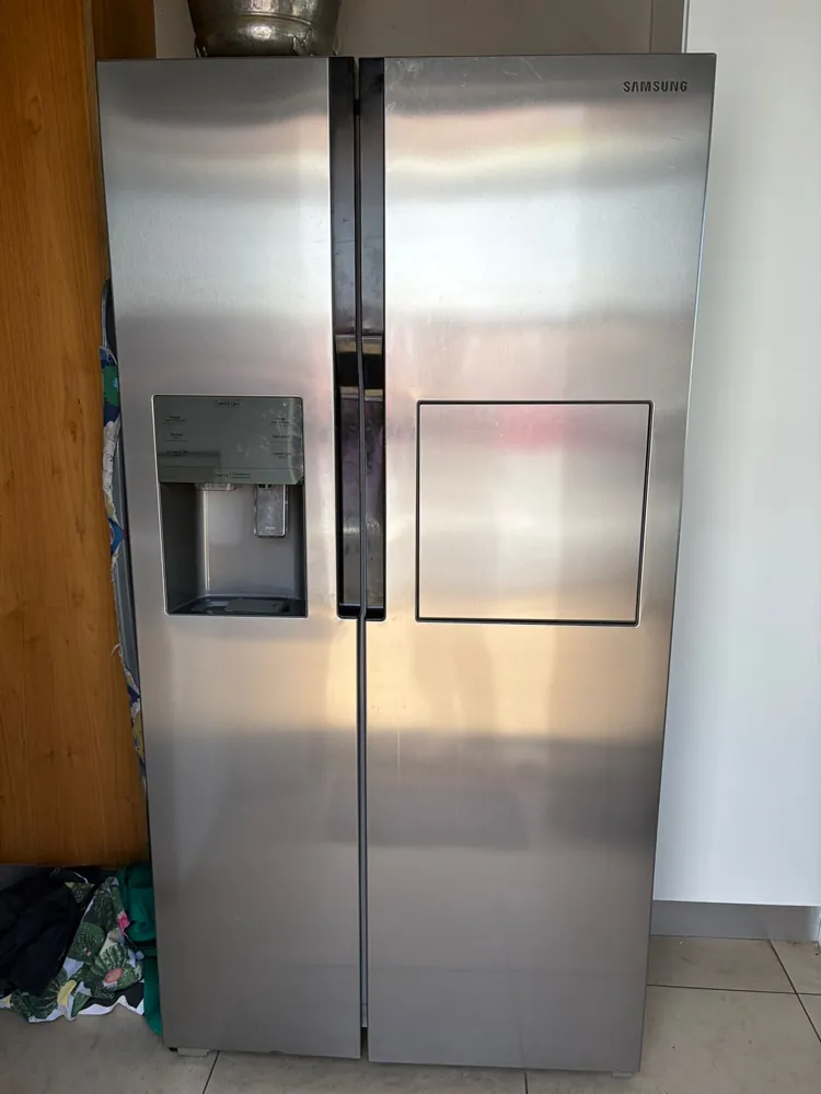 Technician inspecting a refrigerator in Durban